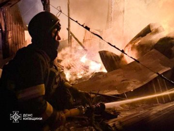 A State Emergency Service firefighter battles flames amid destroyed structures in the Kyiv region following an overnight Russian strike. (Source: DSNS Kyiv)