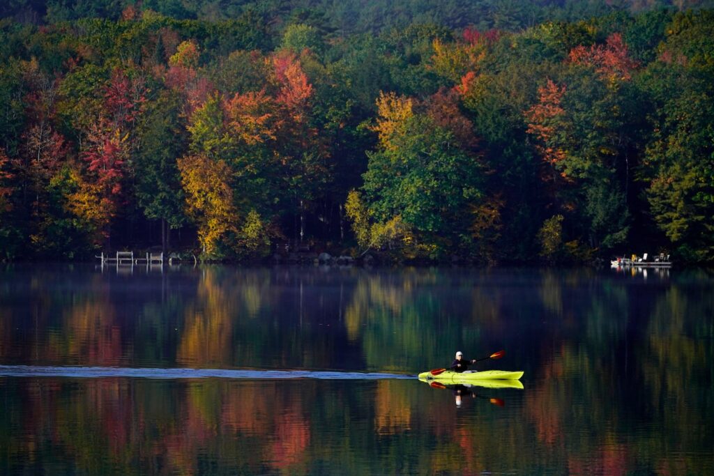 Someone kayaking on a pond in Maine.