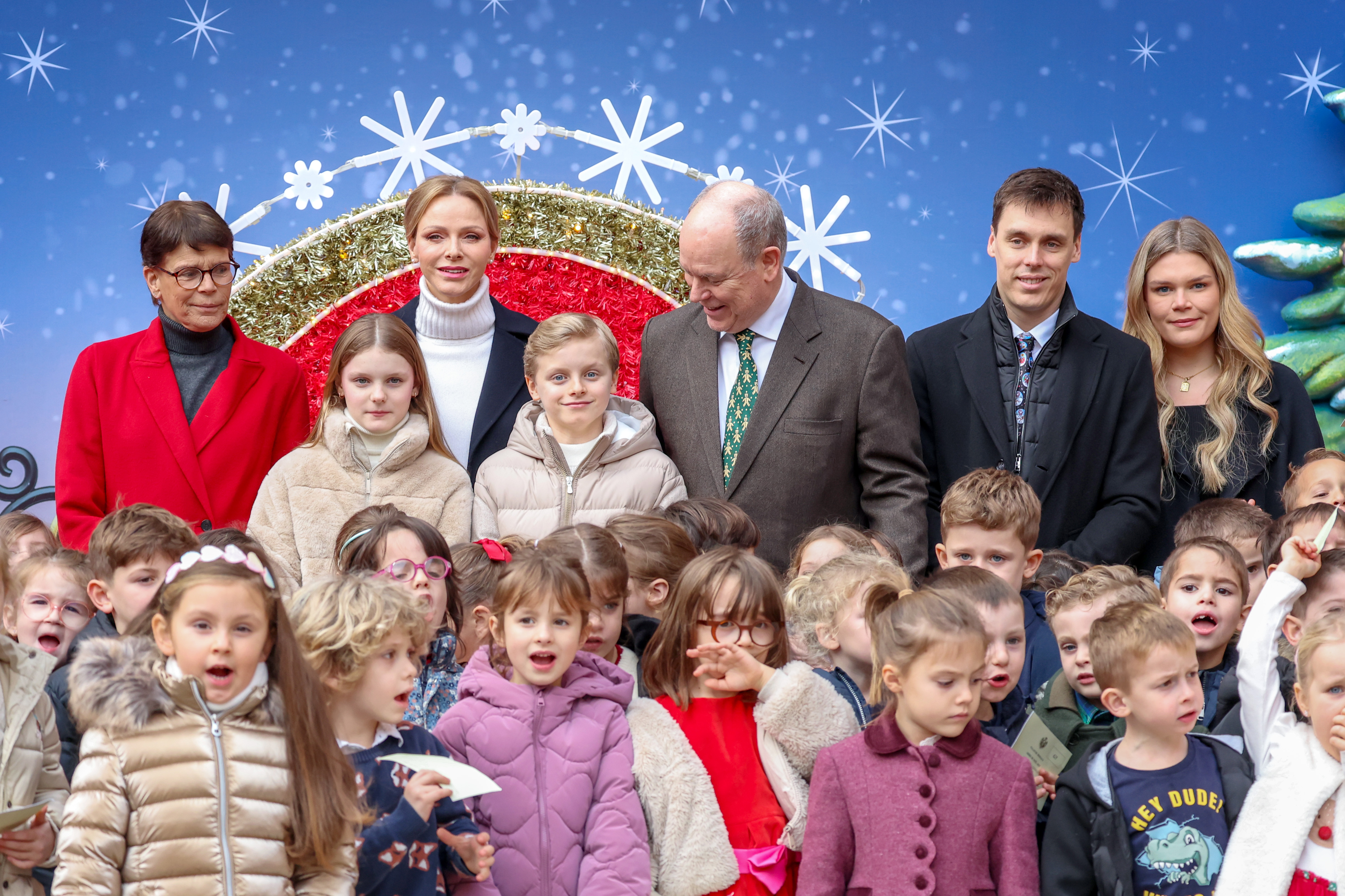 Princess Stephanie of Monaco, Princess Gabriella of Monaco, Princess Charlene of Monaco, Prince Jacques of Monaco, Prince Albert II of Monaco, Louis Ducruet, Camille Gottlieb and local children at a Christmas party
