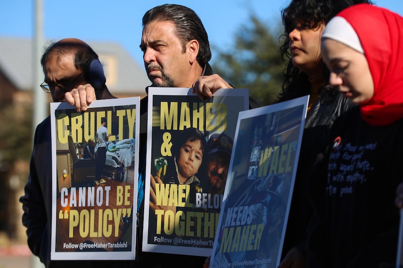Ammar Jumaa, Wael Tarabishi’s uncle, (center) holds signs calling for Maher Tarabishi’s...