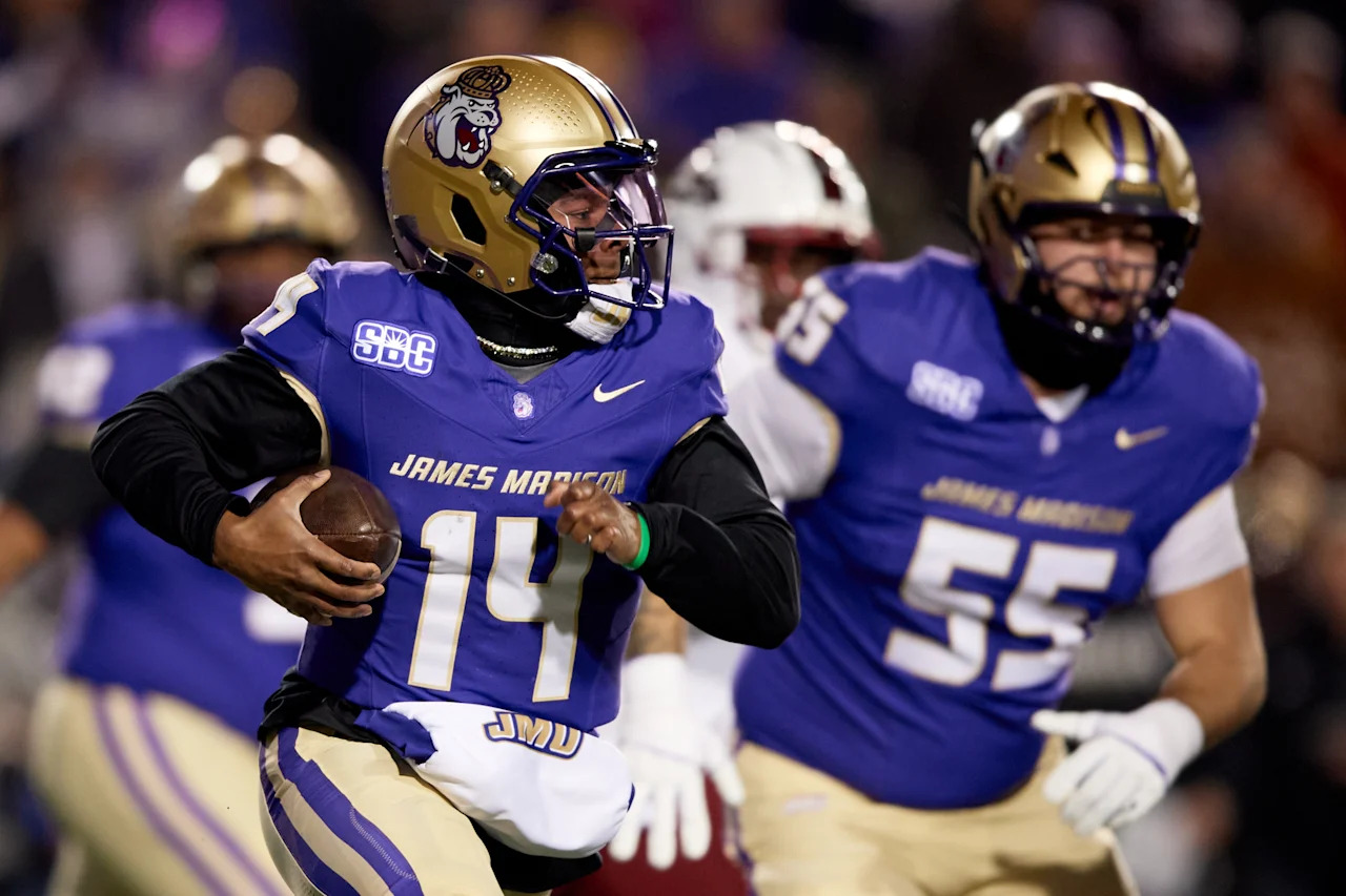 HARRISONBURG, VIRGINIA - DECEMBER 05: Alonza Barnett III #14 of the James Madison Dukes scrambles with the ball against the Troy Trojans during the game at Bridgeforth Stadium on December 05, 2025 in Harrisonburg, Virginia. The Dukes defeated the Trojans 31-14. (Photo by Hannah Foslien/Getty Images)