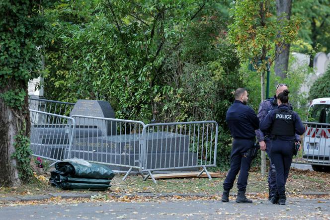 French police officers stand next to the grave of former French Justice Minister Robert Badinter, which had been vandalized a few hours before its moving to the Pantheon, at the Bagneux cemetery in Bagneux, near Paris, October 9, 2025. 