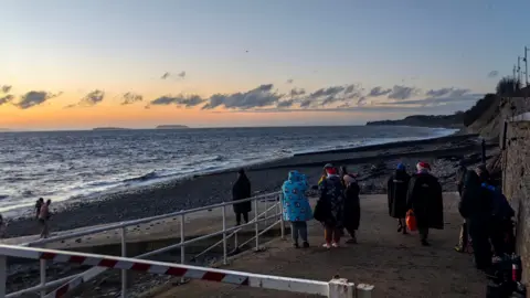 Nadezna / BBC Weather Watchers People gather to watch the Christmas Day sunrise in Penarth