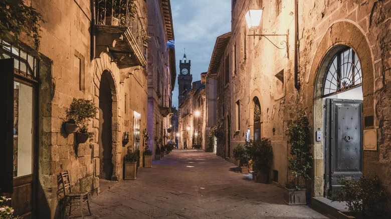 View down a historic alley towards the tower of the Palazzo Publico in Il Campo, Siena
