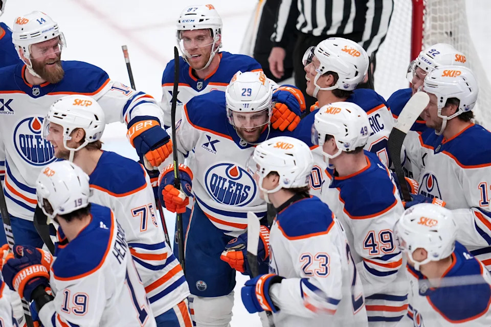 Teammates swarm Draisaitl to celebrate his 1,000th career point. (Gene J. Puskar/AP Photo)