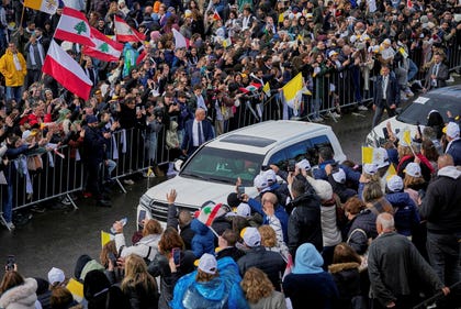 People wave to Pope Leo XIV as he leaves the Monastery of Saint Maroun after praying at the tomb of Saint Charbel Makhlouf in Annaya, Lebanon on Monday.