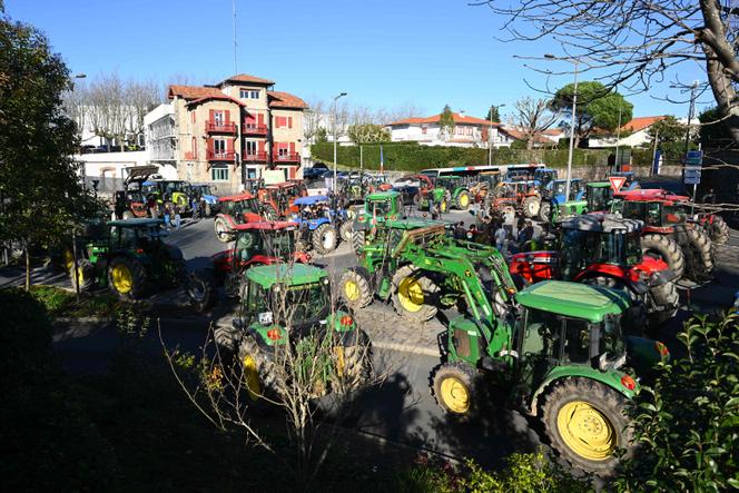 Tractors block a roundabout during a protest called by French farmers unions Coordination Rurale and ELB (Euskal Herriko Laborarien Batasuna) in Saint-Jean de Luz southwestern France on December 14, 2025.