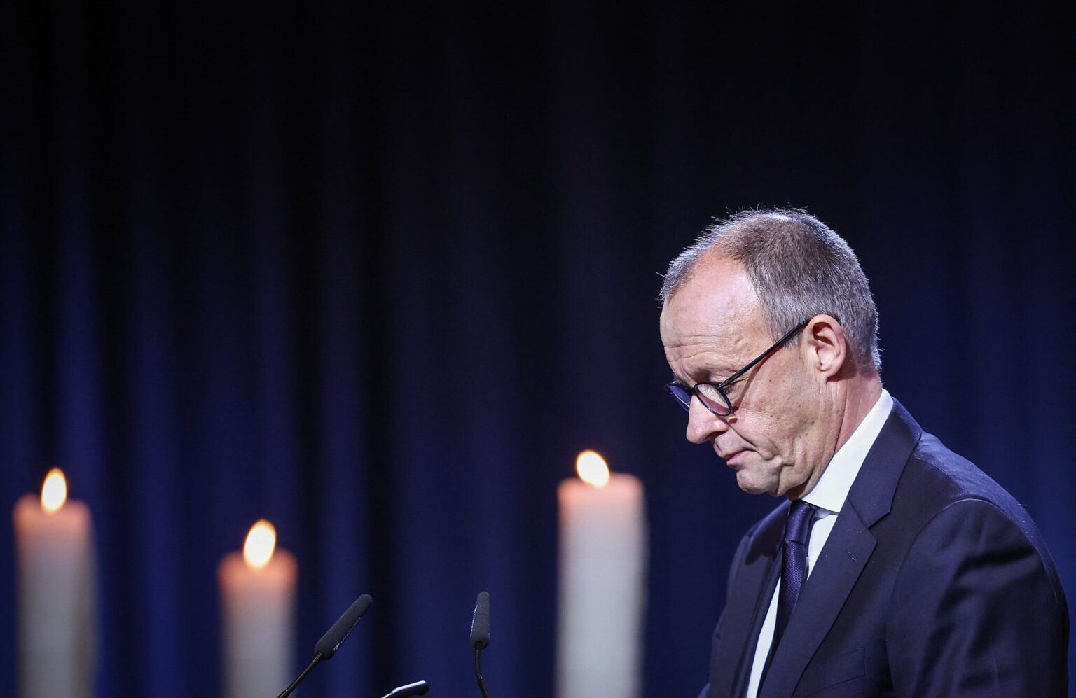 German chancellor urges 'peaceful coexistence,' a year after deadly market attack