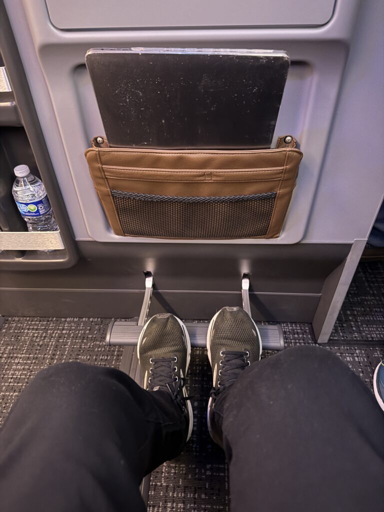 The author uses the footrest in Premium Economy