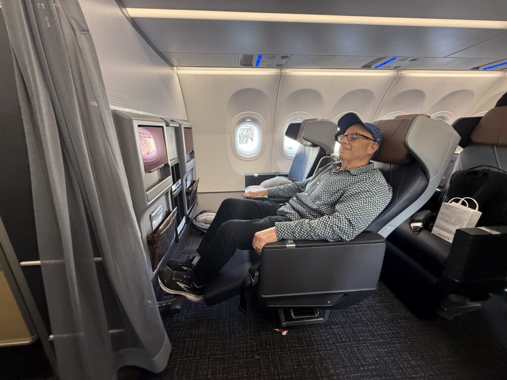 Author Chris Sloan is reclining in the Premium Economy seat.