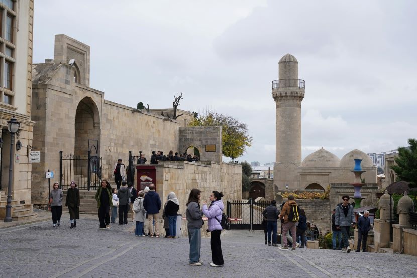 Azerbaijan Showcases Strategic Tourism Potential And Silk Road Connections At The China International Travel Mart In Shanghai A professional promotional display at the azerbaijan national pavilion during a large-scale international travel exhibition in shanghai, featuring tourism banners and representatives.