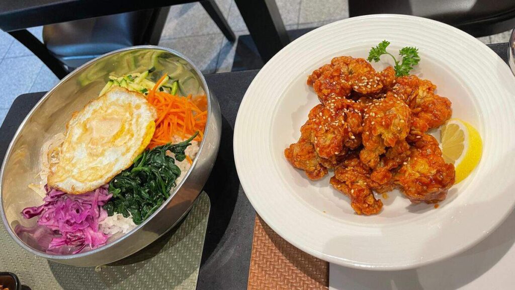Bibimbap and Korean fried chicken with a drizzle of chilli sauce
