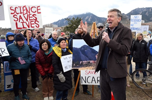 United States Senator from Colorado John Hickenlooper, right, speaks to the crowd during the gathering on Saturday. Hundreds participated in the "Save NCAR" protest along Broadway in Boulder. (Cliff Grassmick/Staff Photographer)