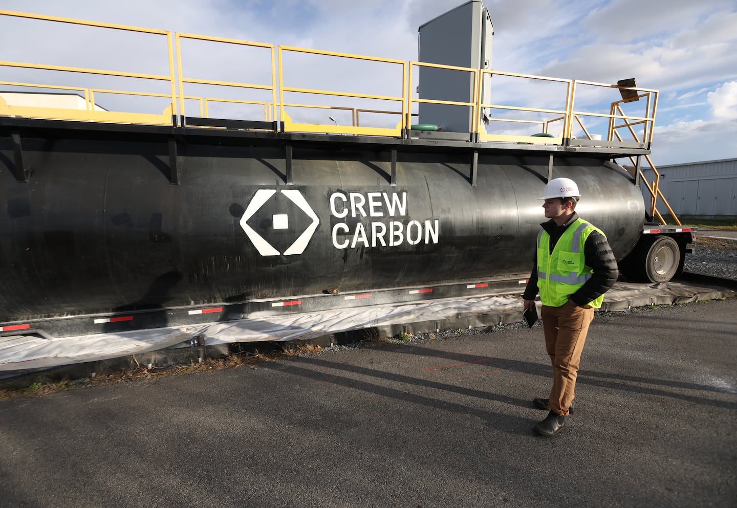 Joachim Katchinoff, the cofounder and CEO of CREW Carbon, stood in front of a tank where the limestone is stored before it is mixed in with waste water in Fall River.