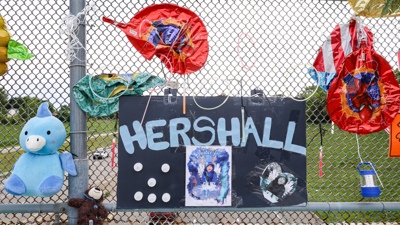 A memorial has been set up on the McClure Street bridge over U.S. Route 35 for Hershall Creachbaum, a 7-year-old who was found dead on July 12. Balloons, stuffed animals and signs are among items people have left. BRYANT BILLING / STAFF