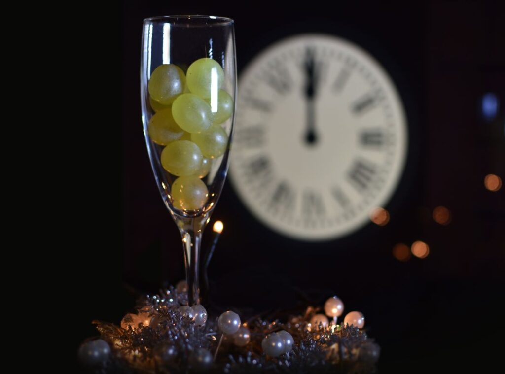 Why do locals in Spain eat 12 grapes to ring in the New Year?