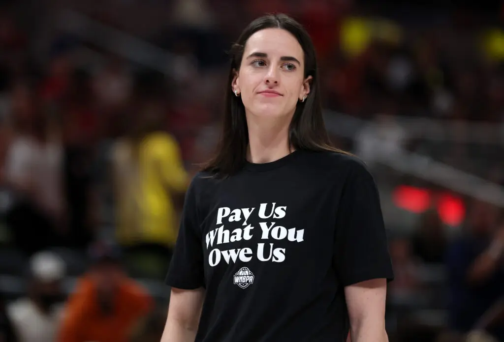 Indiana Fever star Caitlin Clark wears a T-shirt saying "Pay Us What You Owe Us" before the 2025 WNBA All-Star Game.