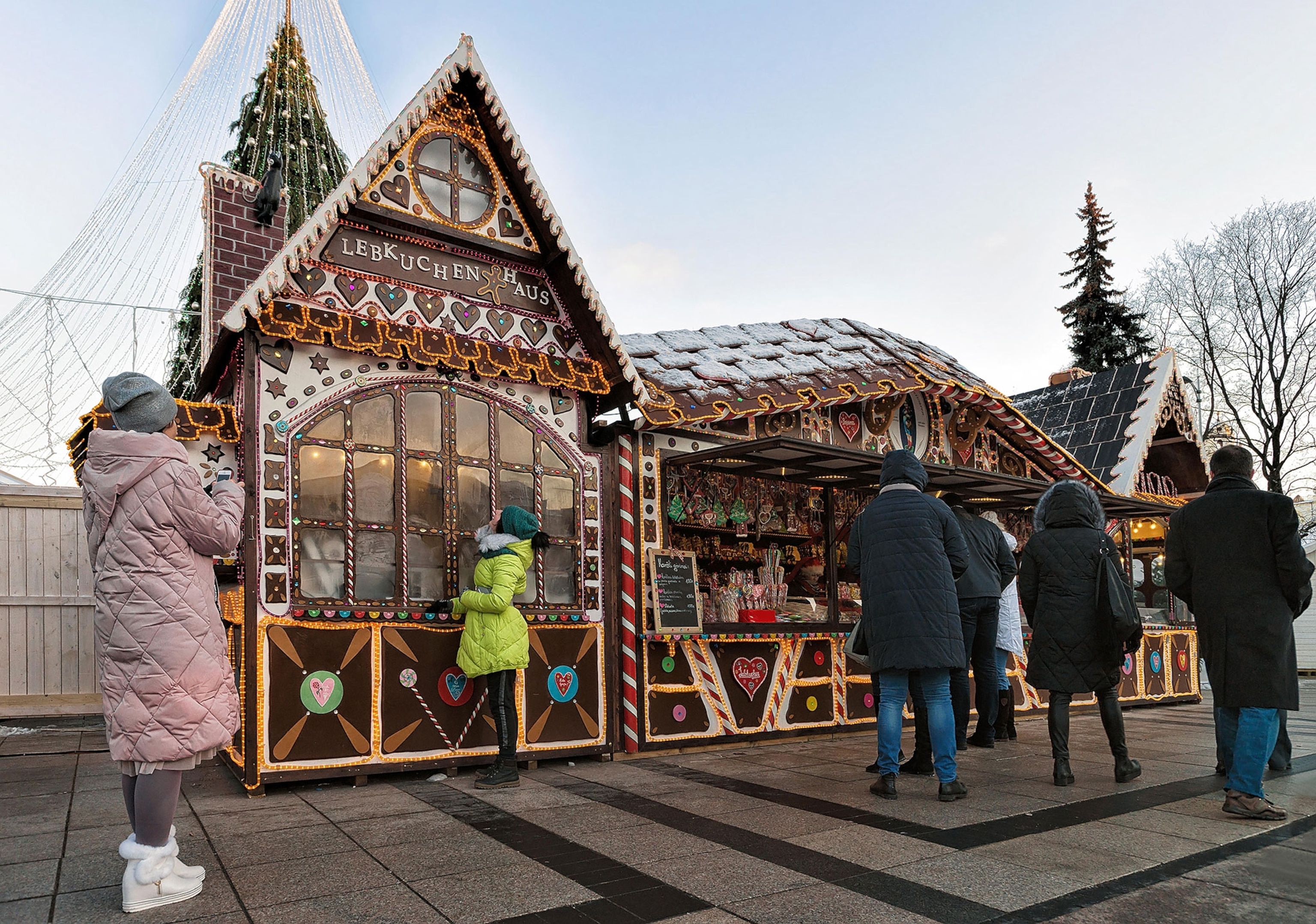 Christmas souvenir house and visitors at Christmas market in Cathedral Square, Vilnius.