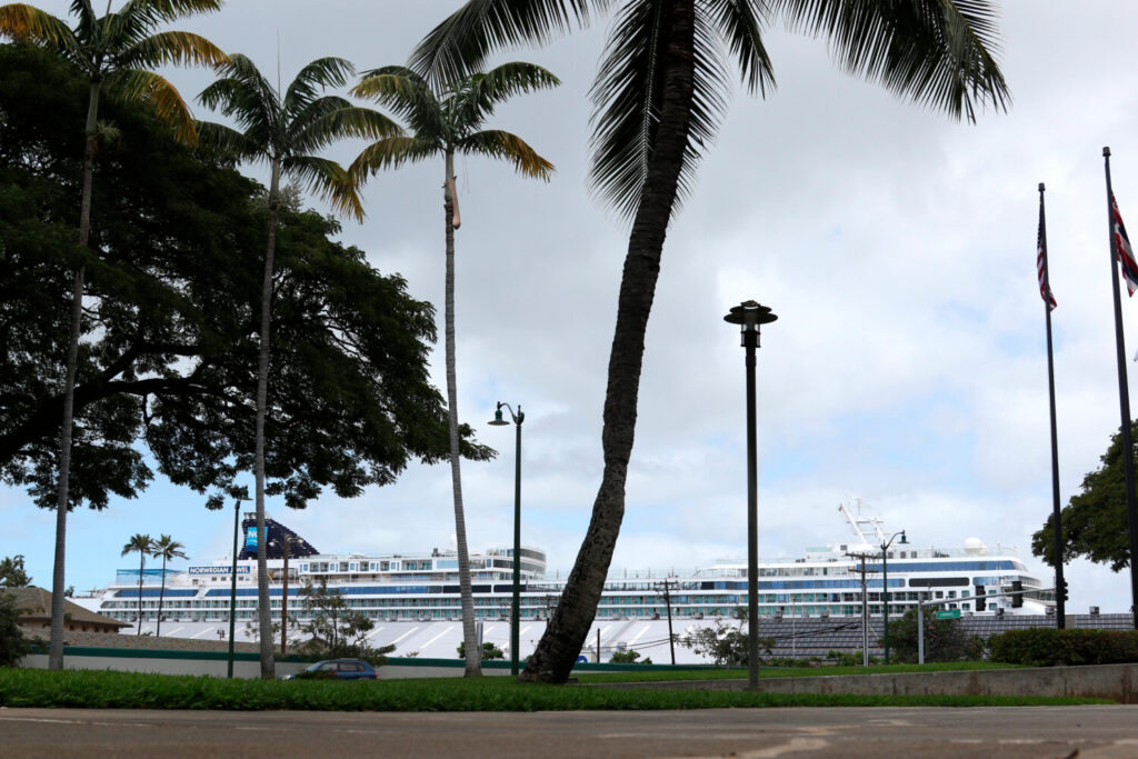 Federal judge upholds Hawaii’s new climate change tax on cruise passengers FILE - A cruise ship, background, is docked in Honolulu, March 23, 2020. (AP Photo/Caleb Jones, Fil...