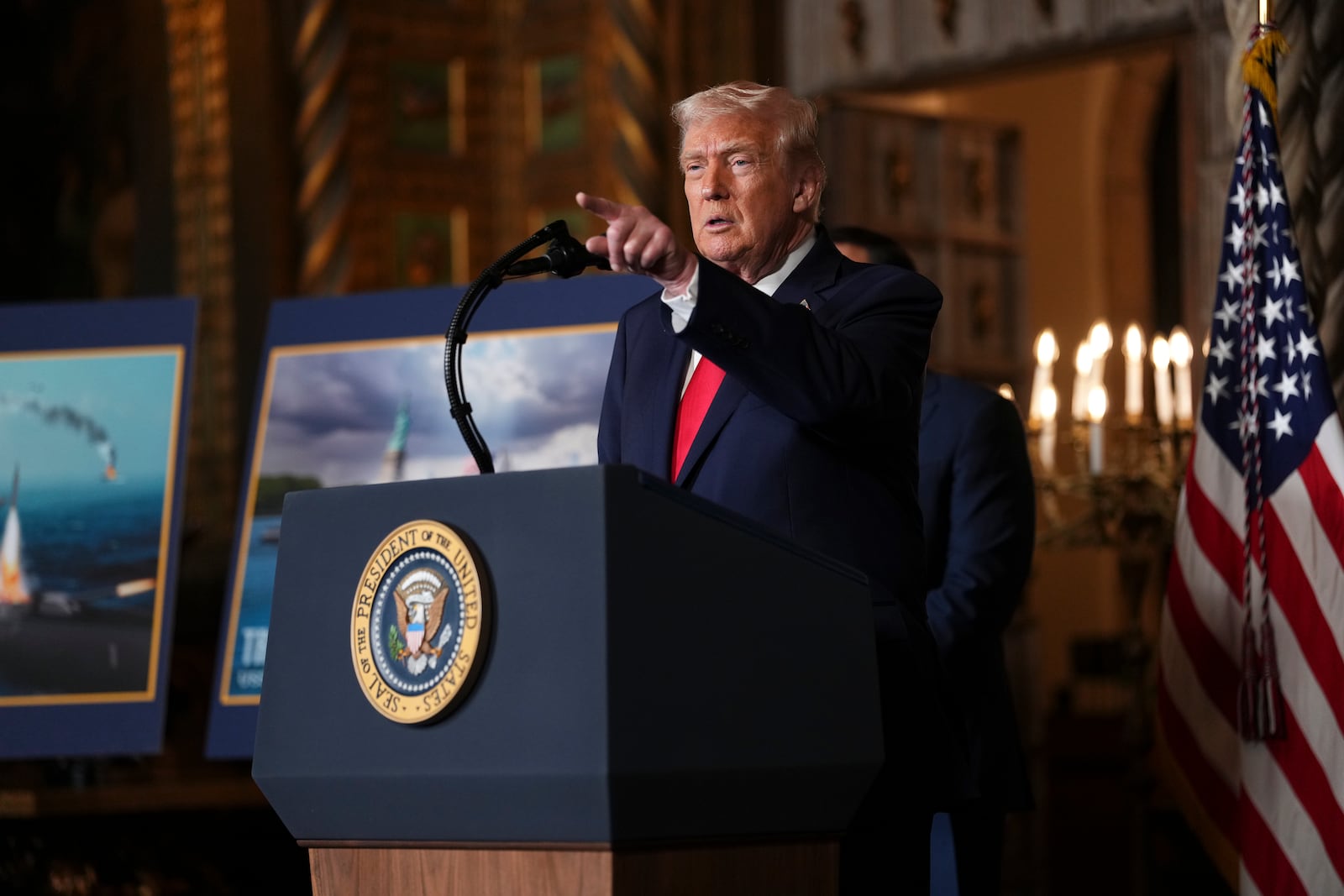 President Donald Trump takes questions from reporters alongside renderings labeled as a “Trump Class” ship for the Navy during an event at Mar-a-Lago in Palm Beach, Fla., on Monday, Dec. 22, 2025. Trump on Monday said he expects the U.S. government to acquire 25 of the new vessels that are expected to be called Trump-class battleships. (Eric Lee/The New York Times)