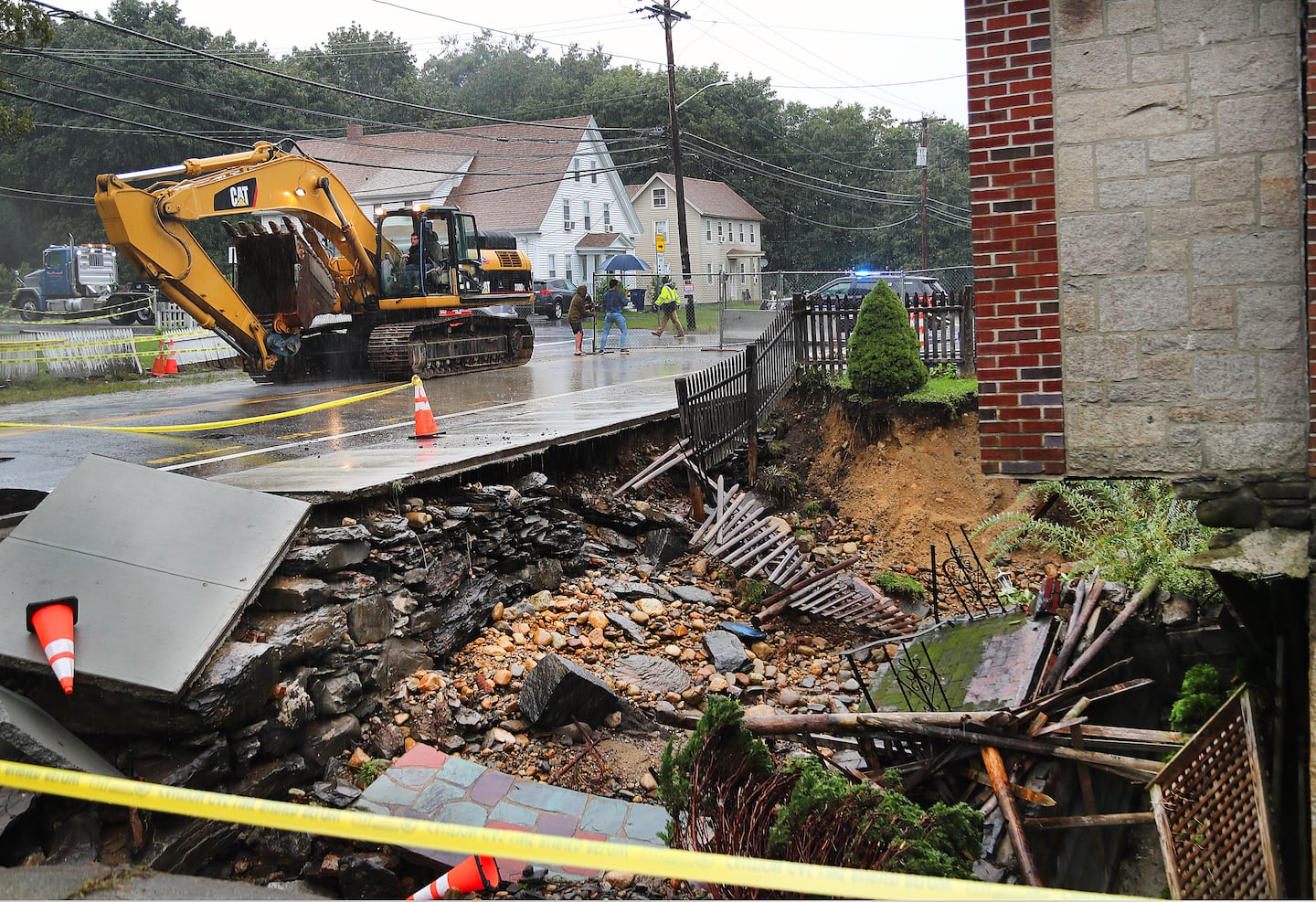 A bucket truck was brought in to work after a massive sinkhole formed following heavy rains, damaging a home on Colburn Street in 2023.  