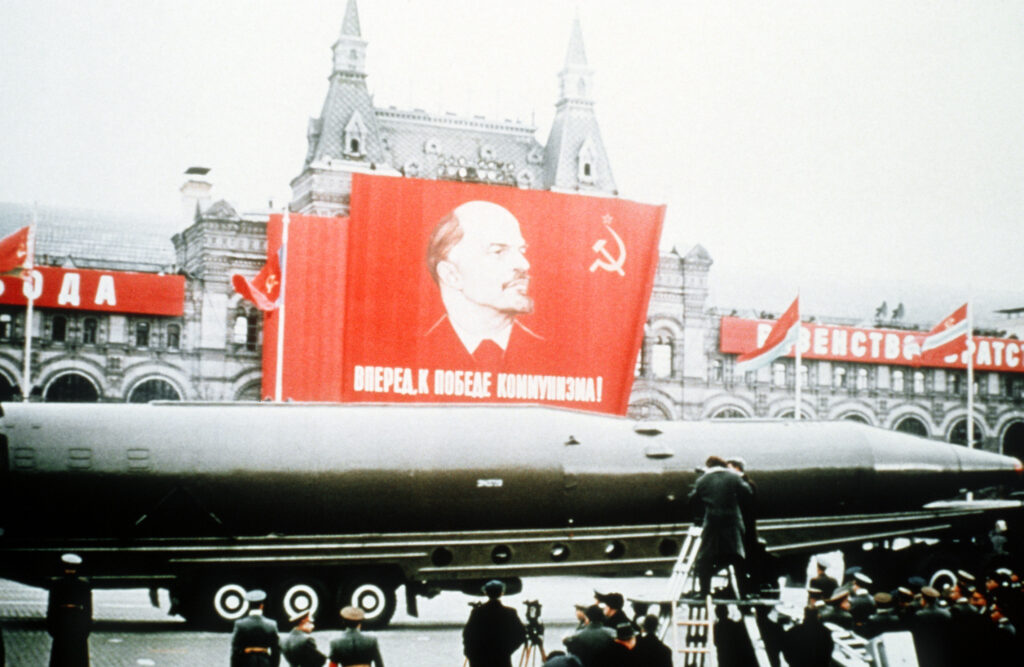 A Soviet SSN-8 intercontinental ballistic missile on display beneath a portrait of Lenin during a military parade in Moscow’s Red Square, 7 November 1964. Public domain.