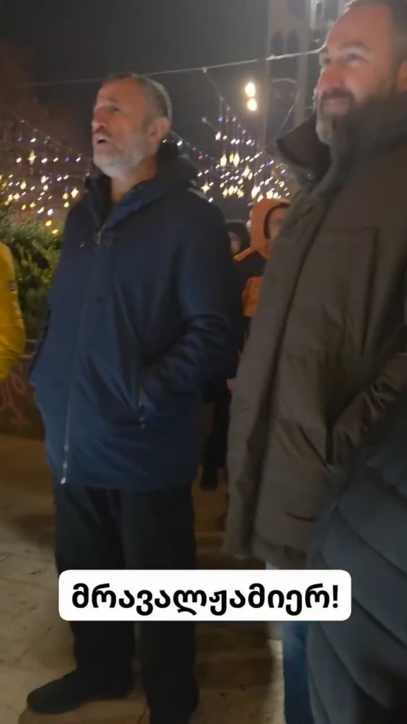 Georgian polyphonic song Mravalzhamieri performed on Rustaveli Avenue on day 385 of nonstop protests in Georgia — celebrating the birthday of Mariam Pirashvili, known for walking around with plastic bags and collecting garbage from protesters to keep the streets tidy.