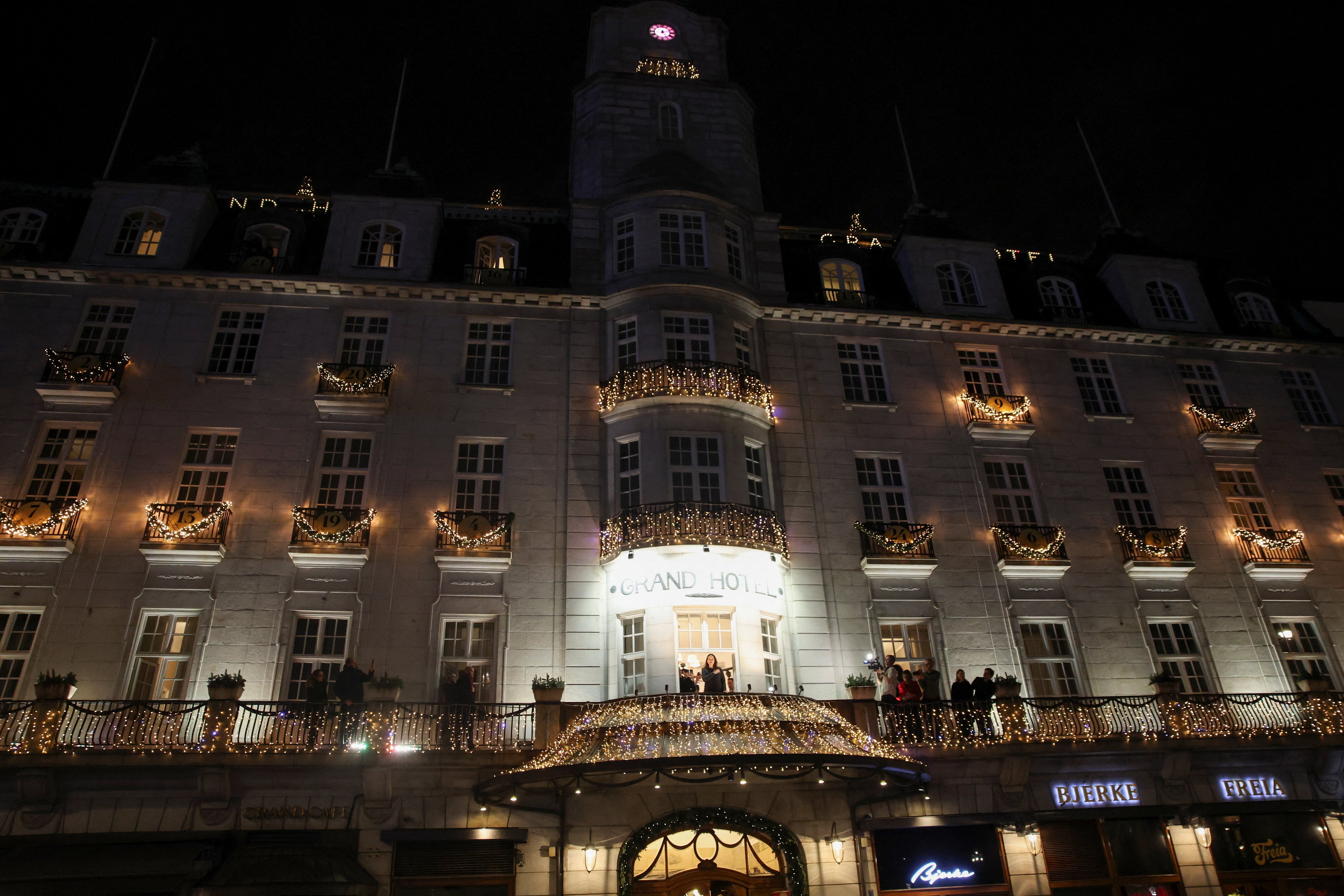 Machado gestures from a balcony of Grand Hotel, after her daughter Ana Corina Sosa Machado, accepted the award on her behalf, in Oslo, Norway