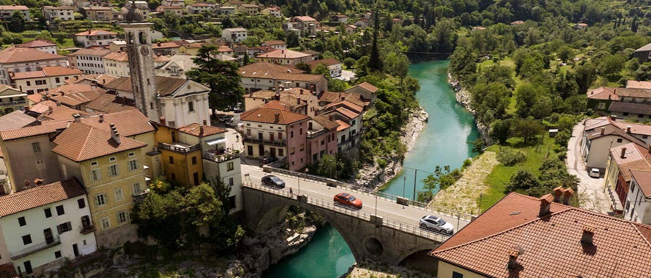 Porsche Macan Electric cars cross bridge in Slovenian town