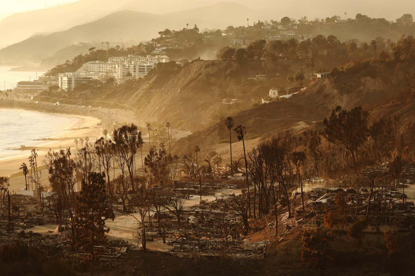 PACIFIC PALISADES, CALIFORNIA - JANUARY 10: A view of destroyed homes as the Palisades Fire continues to burn with wildfires causing damage and loss through Los Angeles County on January 10, 2025 in Pacific Palisades, California. Multiple wildfires fueled by intense Santa Ana Winds are burning across Los Angeles County. Reportedly at least 10 people have died with over 180,000 people having been under evacuation orders. Over 9,000 structures have been damaged or burned while more than more than 25,000 acres were burning from the fires. (Photo by Mario Tama/Getty Images)