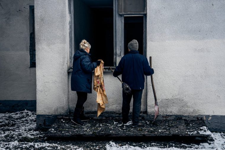 SUMY, UKRAINE - JANUARY 12: Health camp workers clear debris near one of the camp's buildings damaged following a Russian drone attack on January 12, 2025 in Sumy, Ukraine. On January 12, fragments of an intercepted Russian Shahed-type kamikaze drones fell on the territory of the city health camp resulting in partial destruction of the outer wall of one of the buildings, the windows in three buildings and some furniture. At that time, there were no vacationers in the camp, the security guard at the facility was unharmed. Russia continues to pound the Ukrainian border city of Sumy and the Oblast region with kamikaze drones, guided aerial bombs and missiles. (Photo by Pavlo Zarva/Kordon.Media/Global Images Ukraine via Getty Images)