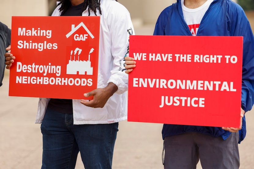People hold signs during a news conference to announce Toxic Twins: Fund the Fund Campaign...