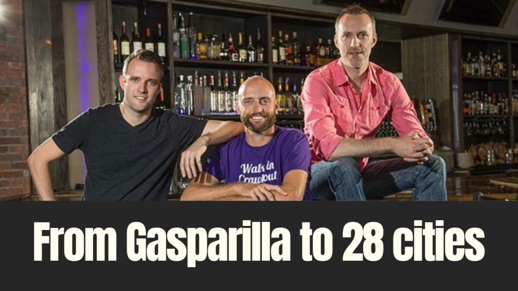 Three founders of Tampa-based Downtown Crawlers pose inside a bar, reflecting the company’s growth from a Gasparilla event to operations in 28 cities.