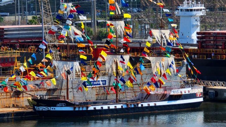 A pirate ship decorated with colorful flags sits along the waterfront ahead of Tampa’s annual Gasparilla parade.