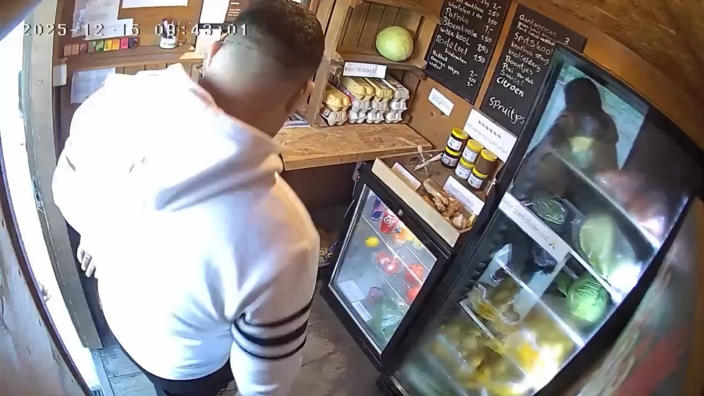 Two Romanians empty a self-service stall in the Netherlands