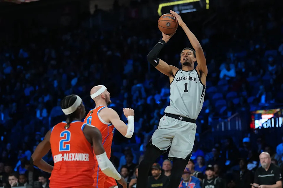 Dec 13, 2025; Las Vegas, Nevada, USA; San Antonio Spurs forward Victor Wembanyama (1) shoots the ball over Oklahoma City Thunder guard Alex Caruso (9) during the third quarter at T-Mobile Arena. Mandatory Credit: Kirby Lee-Imagn Images
