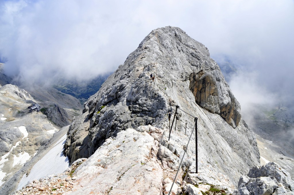 View of the Mount Triglav peak with climbers in the Julian Alps, Slovenia.