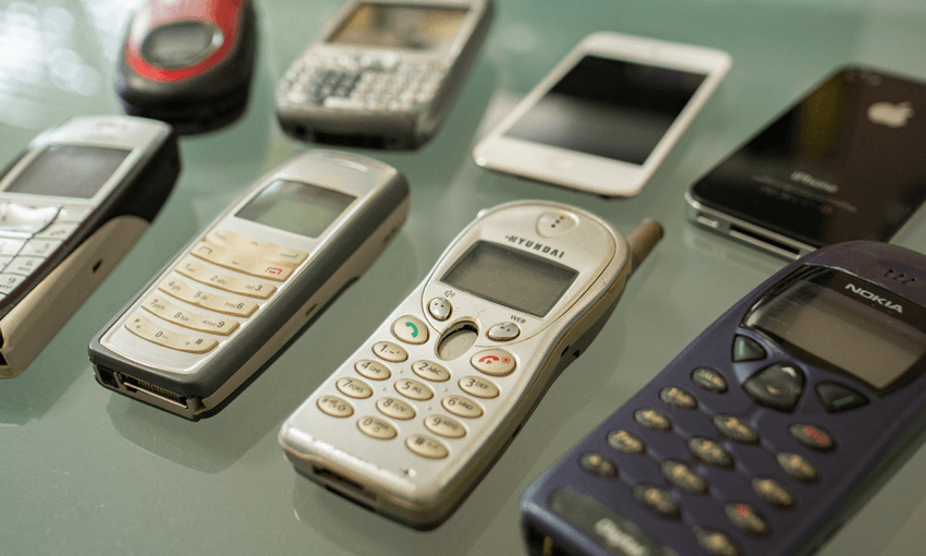 a bunch of old phones from nokia button phones to older smartphones laid on a table