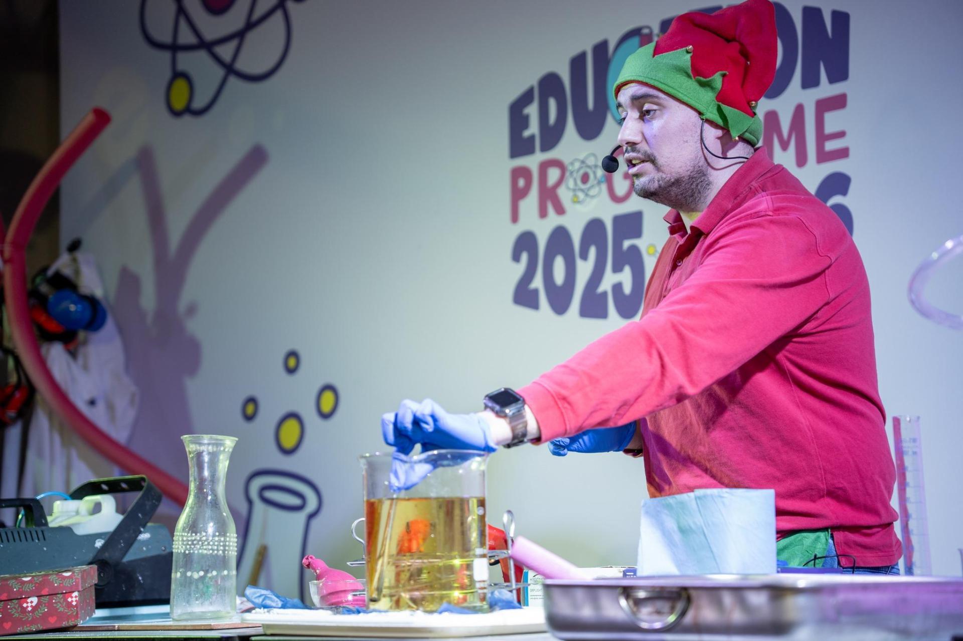 An Esplora team member showing an experiment.