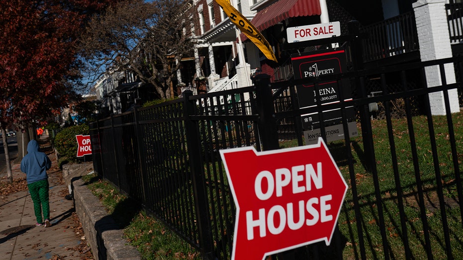 red open house sign posted in front of homes