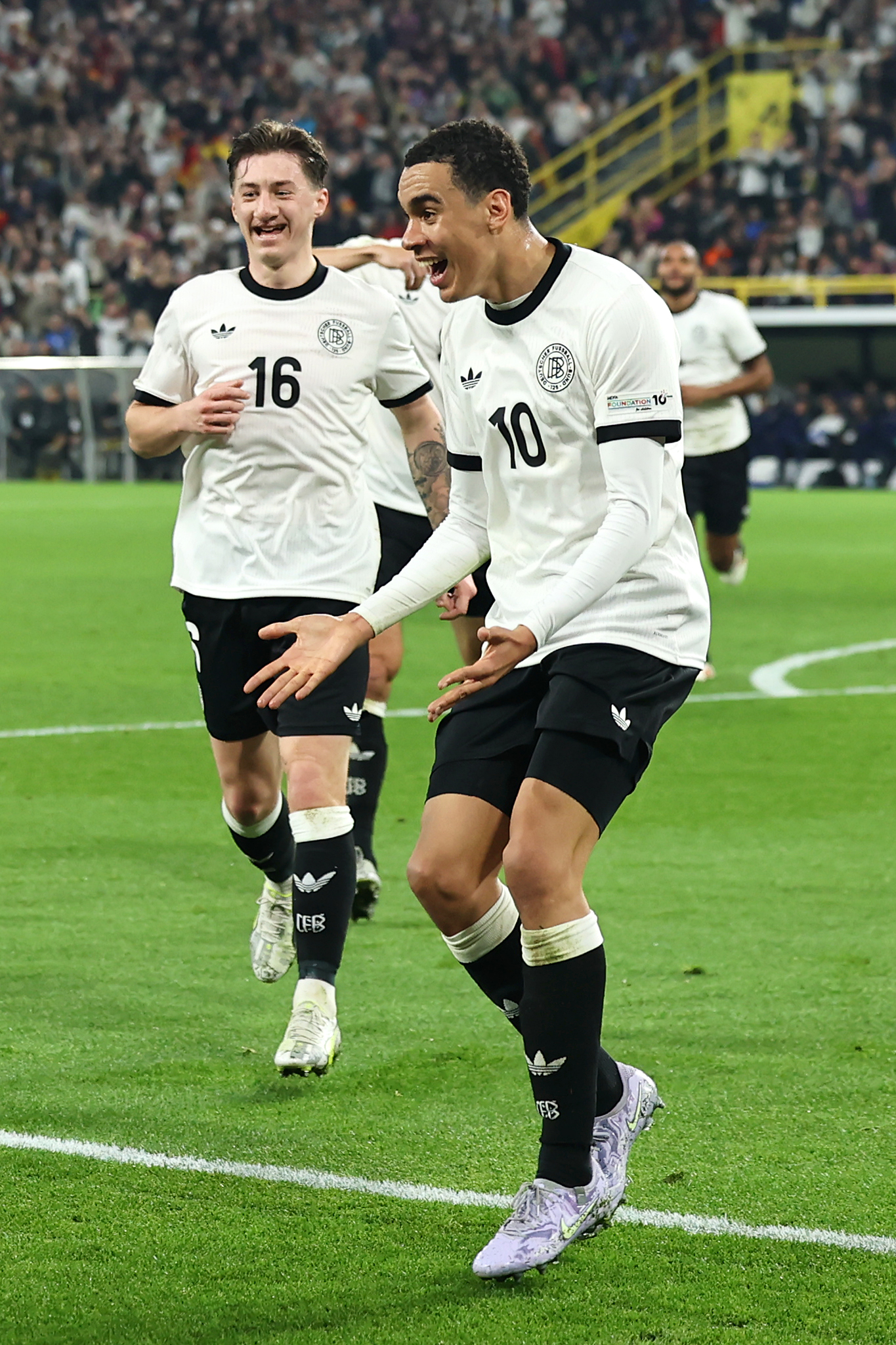 DORTMUND, GERMANY - MARCH 23: Jamal Musiala of Germany celebrates scoring his team’s second goal during the UEFA Nations League Quarterfinal Leg Two match between Germany and Italy at Football Stadium Dortmund on March 23, 2025 in Dortmund, Germany. (Photo by Christof Koepsel/Getty Images for DFB)