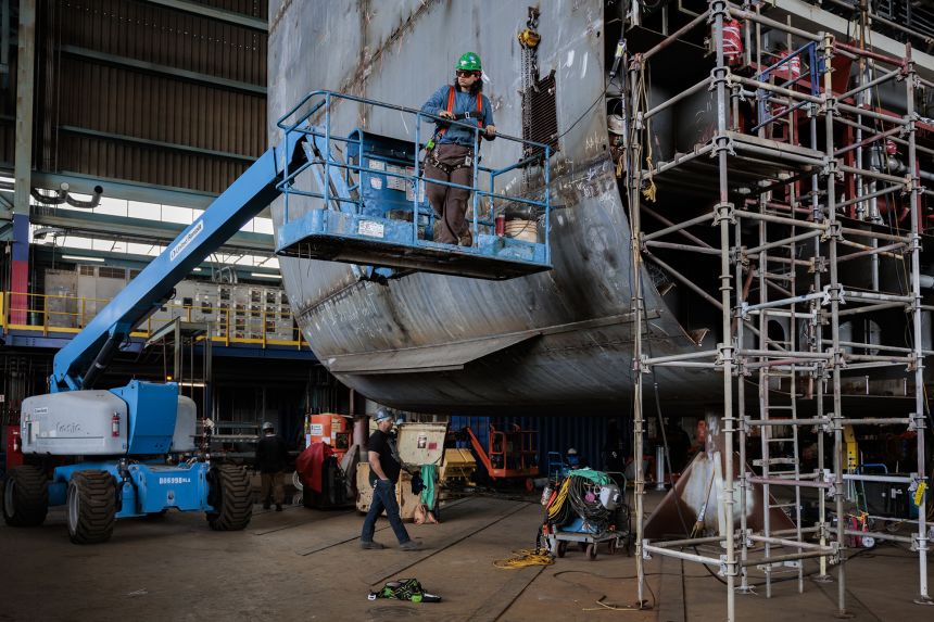 Workers construct a grand block of the National Security Multi-Mission Vessel Five (NSMV V), a training platform for state maritime academies, in the grand block shop at the Hanwha Philly Shipyard in Philadelphia, Pennsylvania.