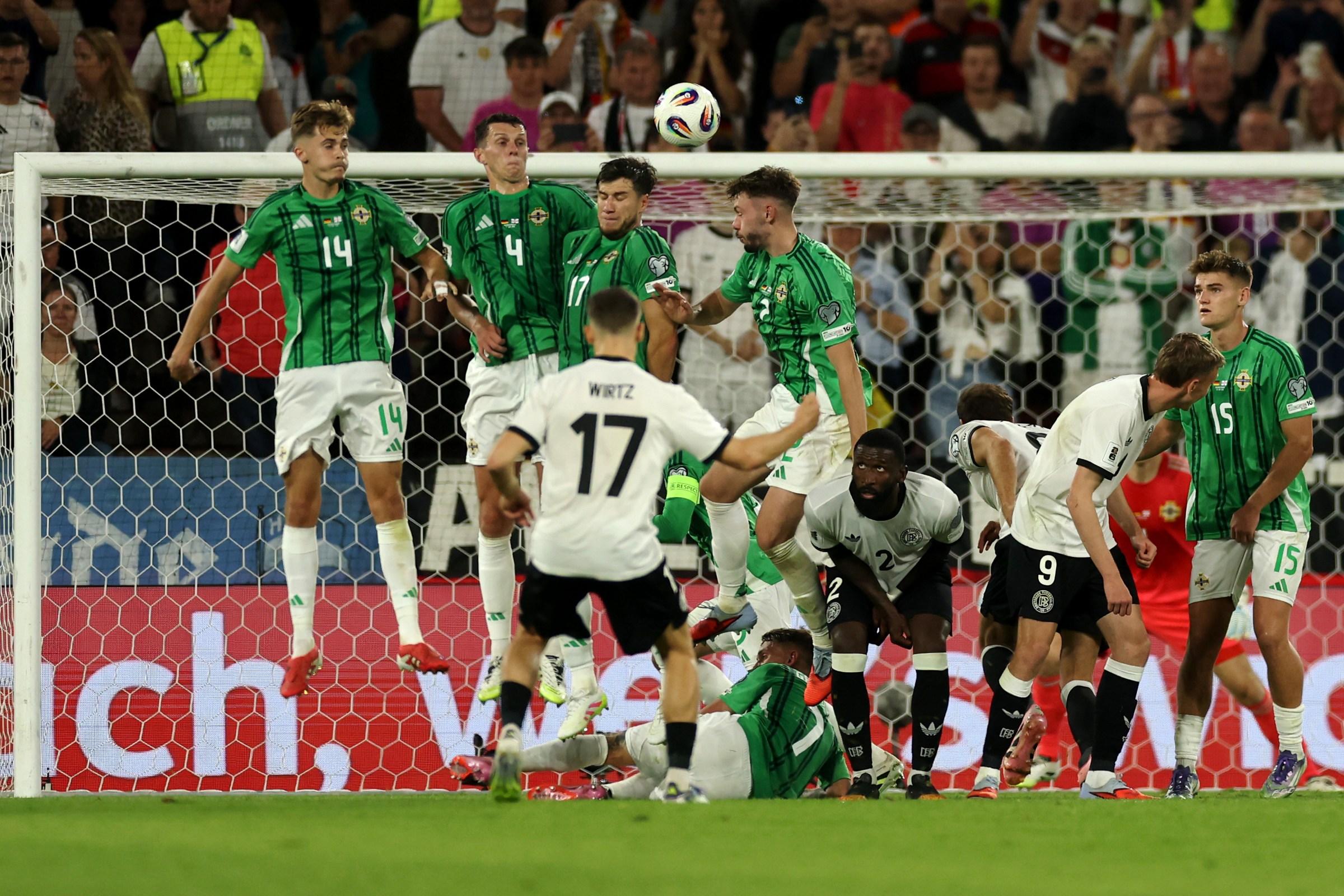COLOGNE, GERMANY - SEPTEMBER 07: Florian Wirtz #17 of Germany scores his team’s third goal from a free kick over the Northern Ireland wall past goalkeeper, Bailey Peacock-Farrell during the FIFA World Cup 2026 qualifier match between Germany and Northern Ireland at RheinEnergieStadion on September 07, 2025 in Cologne, Germany. (Photo by Dean Mouhtaropoulos/Getty Images)