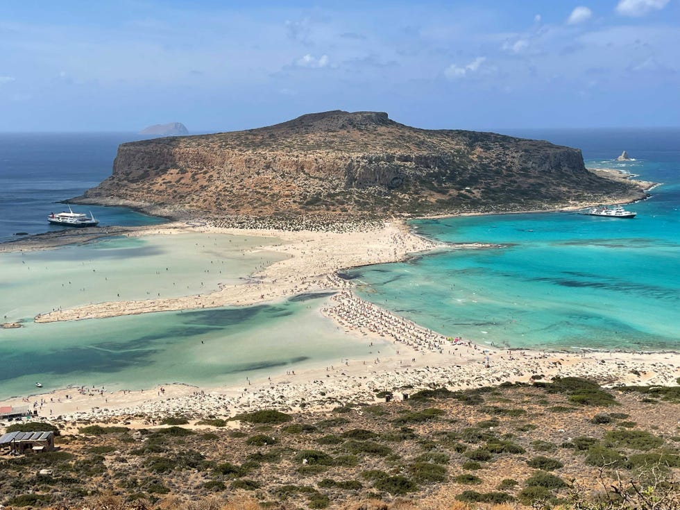 aerial view of a beach with turquoise waters and a sandy peninsula