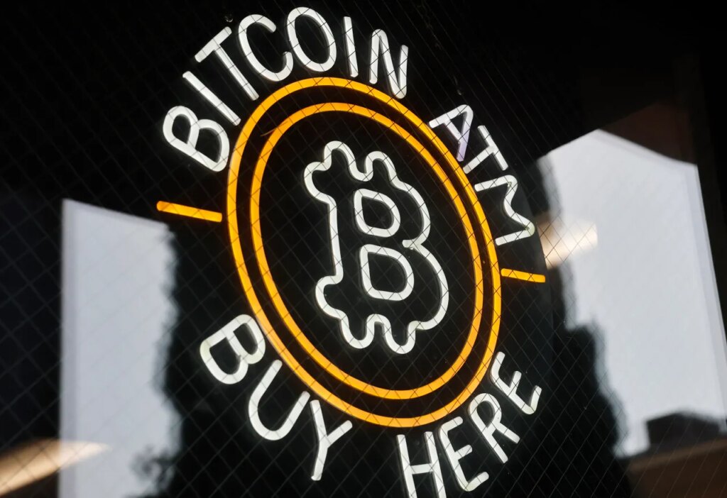 A sign advertises a Bitcoin ATM at a gas station on July 16, 2025 near Pasadena, California. (Photo by Mario Tama/Getty Images)