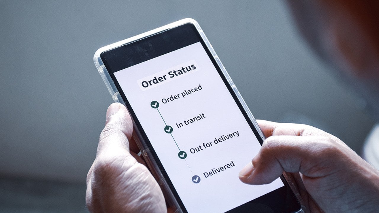 Person checking the order status of an item using smartphone.