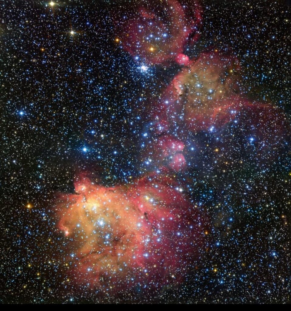 Emission nebula and dense star field within the Milky Way galaxy