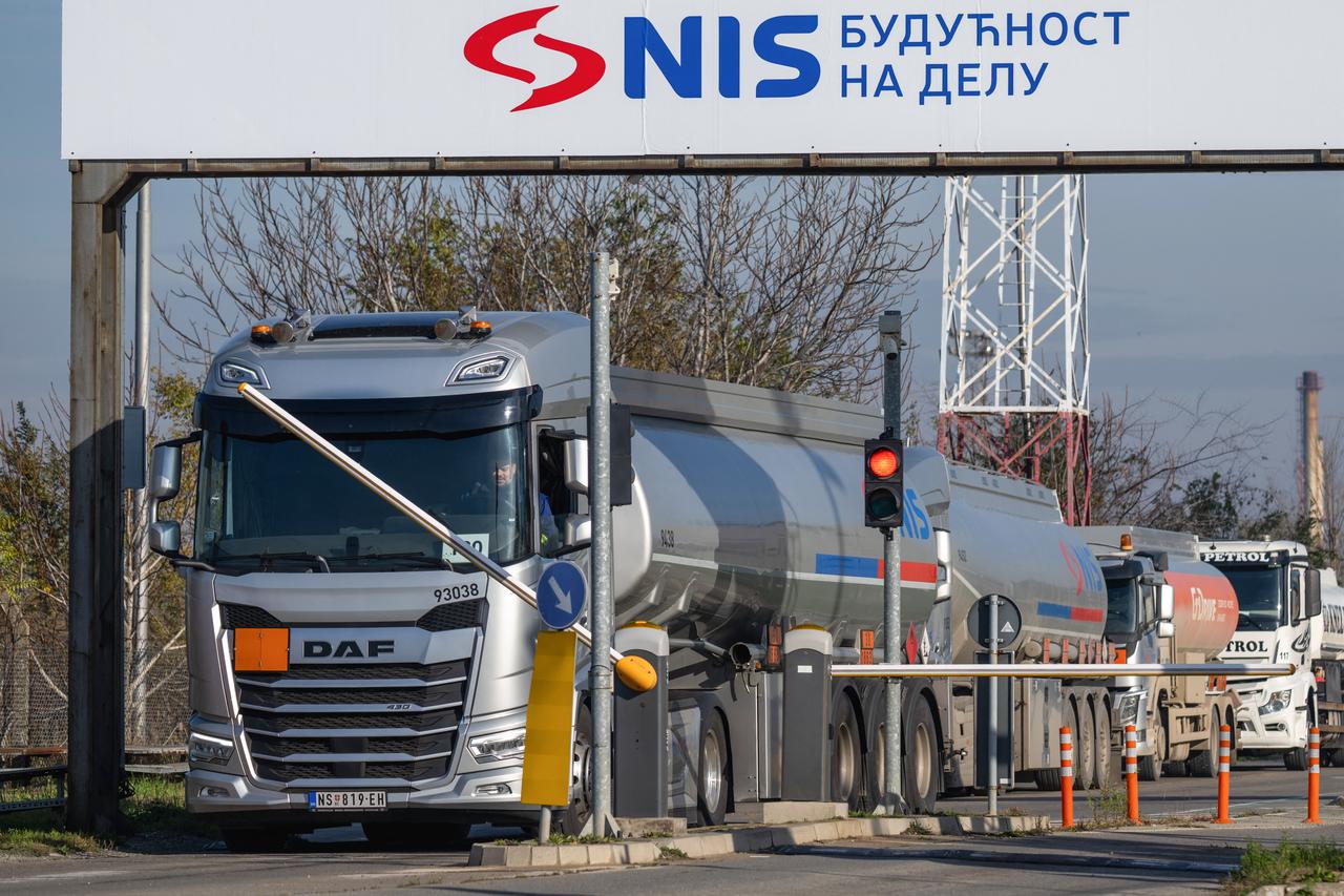 A tanker truck rides behind an inscription which reads as "NIS - The Future in Action" as leaving the grounds of the Petroleum Industry of Serbia (NIS) in Pancevo, Serbia on Dec. 10, 2025. (AFP Photo)