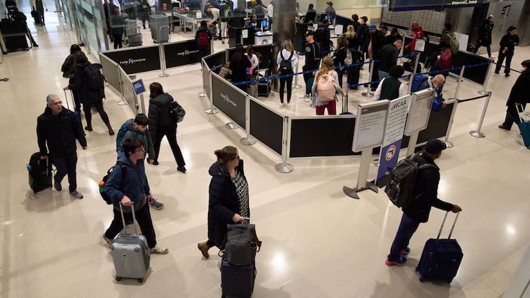 Travelers wait in a TSA checkpoint at Detroit Metropolitan Wayne County Airport.