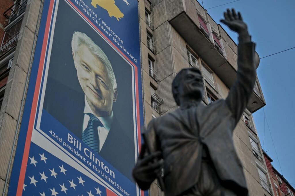 This photo shows a big banner depicting a portrait of former U.S. president Bill Clinton and a statue dedicated to him in Pristina, Kosovo on March 22, 2024. (AFP Photo)